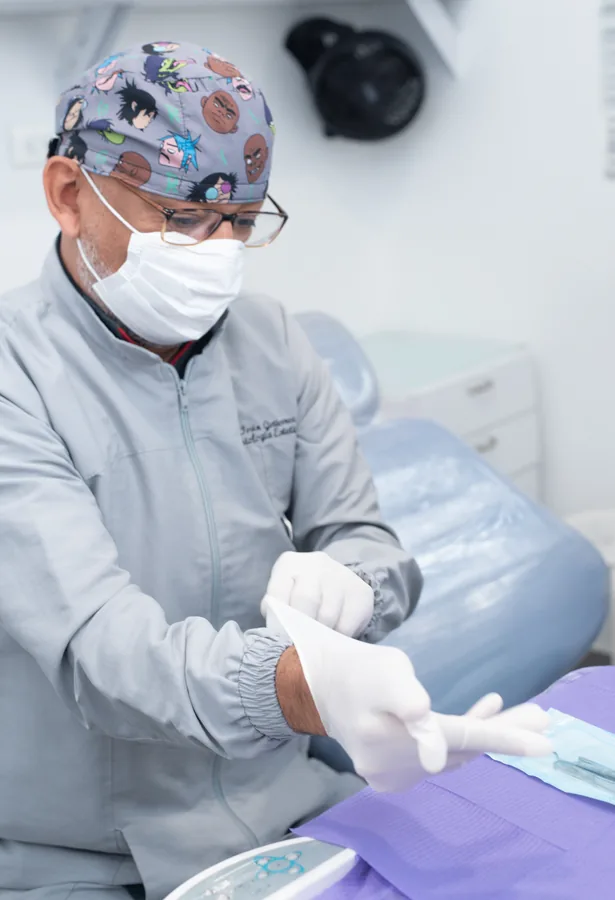 Dr. Ivan guantes - Dental specialist performing precise surgical procedure at DentiCenter