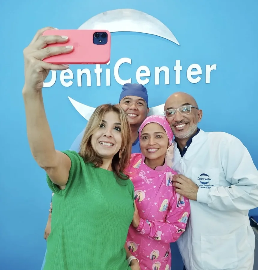 Happy patients and dental team celebrating successful treatment